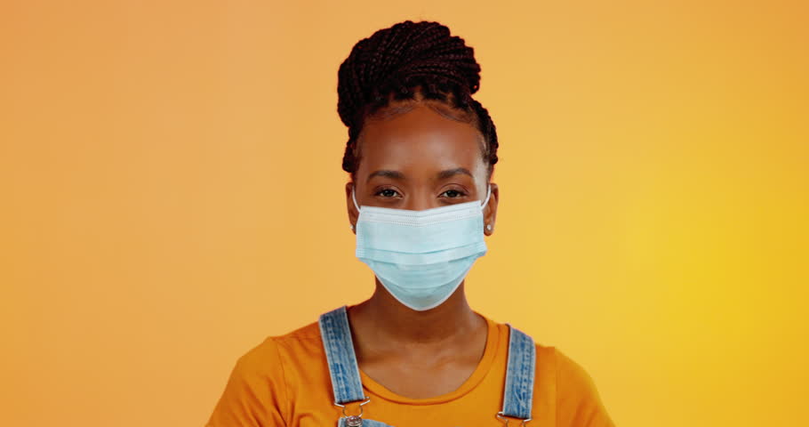 Covid face mask, cough or black woman sick via corona virus, studio health problem or flu disease. Healthcare crisis, medical emergency or portrait person with bacteria infection on orange background | Shutterstock HD Video #1102058729