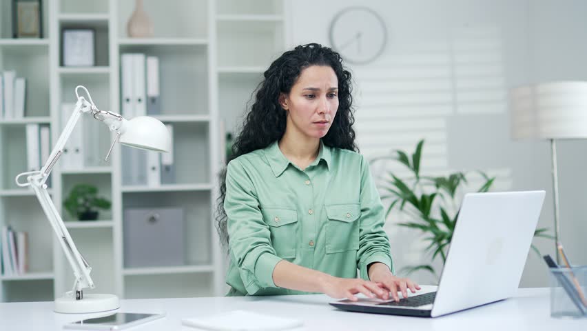 Tired employee office worker businesswoman feeling headache while working on laptop at workplace in office Sad and overworked woman massages her temples and rubs a sore spot with her hands indoor Royalty-Free Stock Footage #1102061875