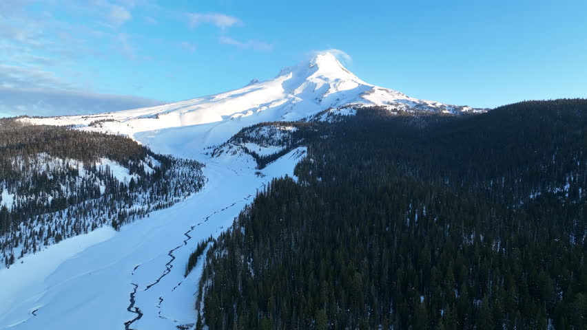 Bright morning light shines on Mt Hood, an iconic stratovolcano found about 50 miles southeast of Portland, Oregon. Mt Hood has one of the longest ski seasons in the U.S. due to its annual snow pack.