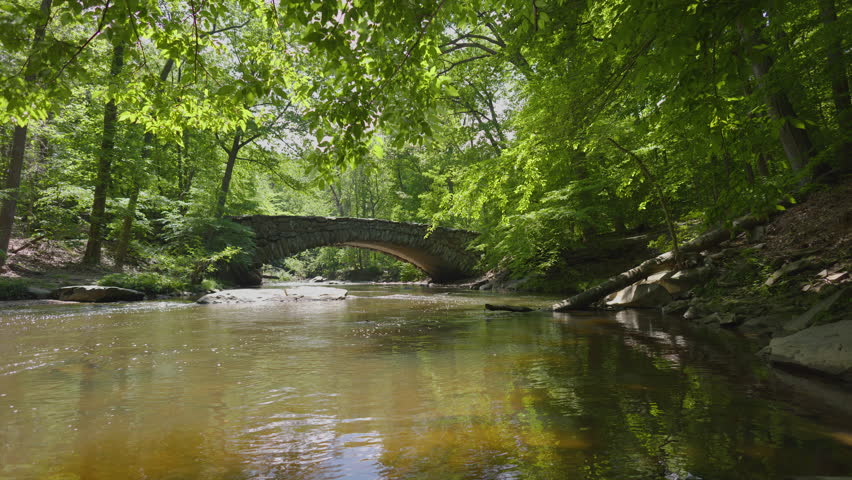 On a spring day, Rock Creek flows under Boulder Bridge in Washington DC