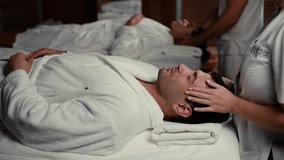 Close up shot of a caucasian young couple lying with his eyes closed receiving relaxing head massage at the spa salon. relaxation rejuvenation relief and wellness concept. - Powered by Shutterstock - Get 15% off with code: PIKWIZARD15