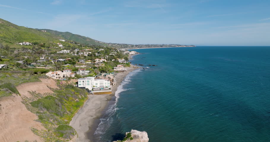 El Matador Beach Malibu California Aerial Ocean View - Waves with Rocks. 
Drone flyover waves crashing on rocky beach. Aerial view of waves rolling into the shore. 