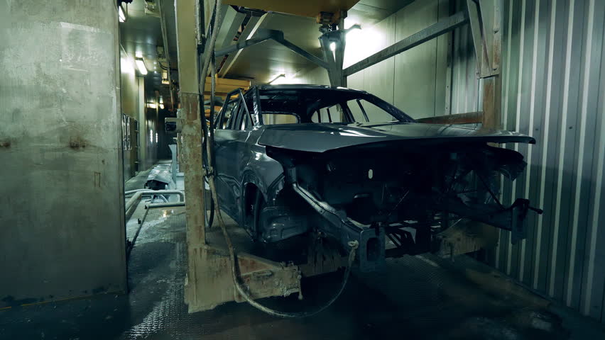 Unfinished body of a car is getting mechanically transported