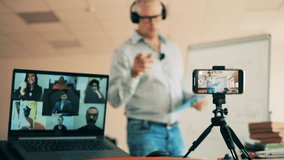 Online lesson conducted by a male teacher for multiple students - Powered by Shutterstock - Get 15% off with code: PIKWIZARD15