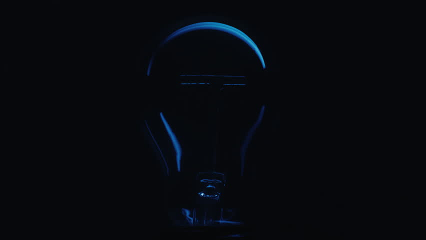 Close up shot of the filament inside a decorative incandescent bulb turning on, glowing dimly and turning off Royalty-Free Stock Footage #1102071435
