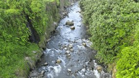 Aerial footage of flowing water in the ravine with low altitude, taken with a drone