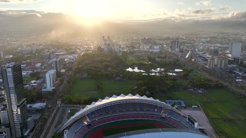 Downtown San Jose, Costa Rica drone video at sunrise. Aerial view of the National Stadium and La Sabana Park. Royalty-Free Stock Footage #1102076897