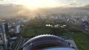 Downtown San Jose, Costa Rica drone video at sunrise. Aerial view of the National Stadium and La Sabana Park.