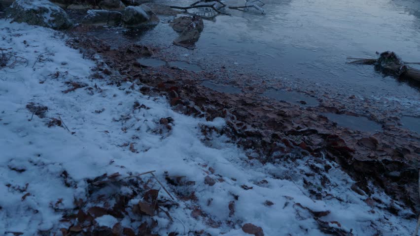 Langbathseen, Ebensee, Austria. Beautiful, cold morning in the austrian alps. Clear sky, golden sunlight hitting the mountain in the background. Clear water reflecting the alps. Snowy winter forrest,