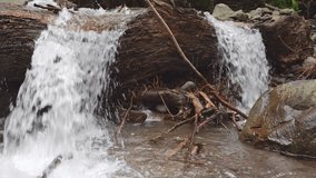 Water flowing on the mountain river when rainy season with water motion through the river stone. The footage is suitable to use for environment and fresh water content media.