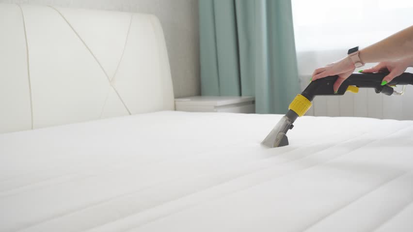 General cleaning of the house. Cleaning the mattress with a modern vacuum cleaner. Royalty-Free Stock Footage #1102081517