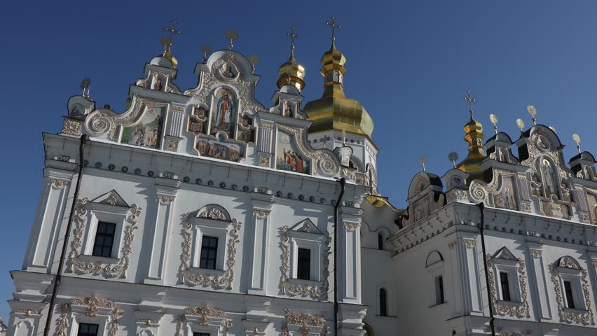 Beautiful view of the Assumption Cathedral of the Kiev-Pechersk Lavra. View of the cathedral from the outside. Beautiful golden domes and blue skies.