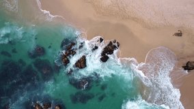 4k aerial drone footage video of a beach with rocks landscape in oaxaca, mexico, travel in america summer, waves, natural park, coast in the pacific ocean with no people huatulco holidays
