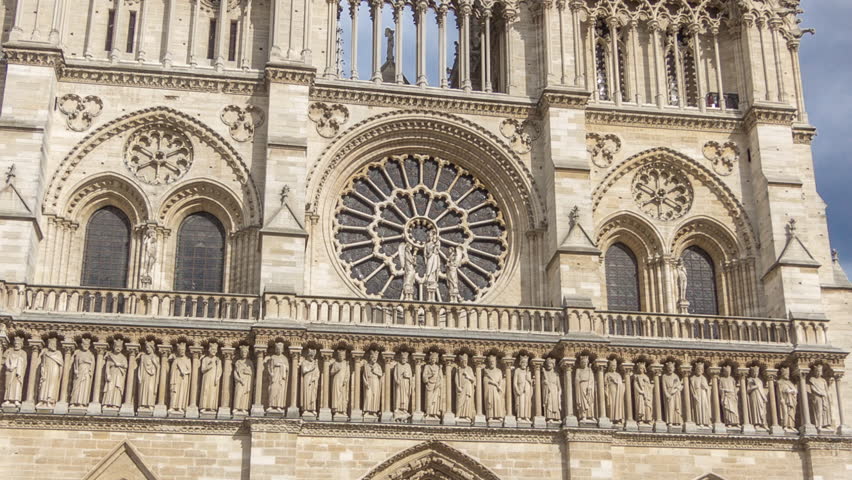 Front view of Notre-Dame de Paris timelapse hyperlapse. Medieval Catholic cathedral on the Cite Island in Paris, France. Long queue of tourists near the entrance. Cloudy sky at summer day