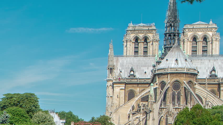 Notre Dame de Paris back side timelapse. One of the most famous symbols of Paris. Bridge of the Archbishopric. View from Siene waterfront at sunny summer day
