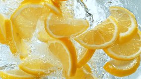 Super Slow Motion Shot of Fresh Lemon Slices Falling into Water Whirl on Light Background at 1000fps - Powered by Shutterstock - Get 15% off with code: PIKWIZARD15
