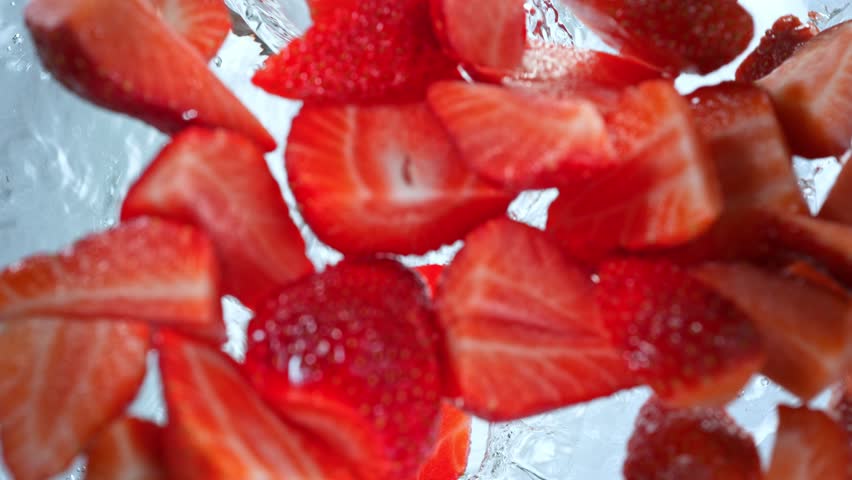Super Slow Motion Shot of Fresh Strawberries Falling into Water Whirl at 1000 fps. Royalty-Free Stock Footage #1102087809