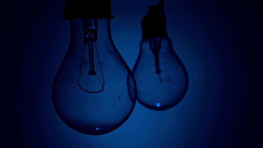 Light bulb turns on and goes out at the touch of a person's hand in the dark. Slow turning on and off of a tungsten light bulb. Filament of a blinking vintage light bulb. Energy, electricity, light Royalty-Free Stock Footage #1102087929