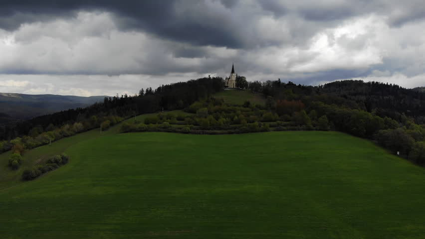 Old church on the hills with thunderclouds drone view. High quality 4k footage