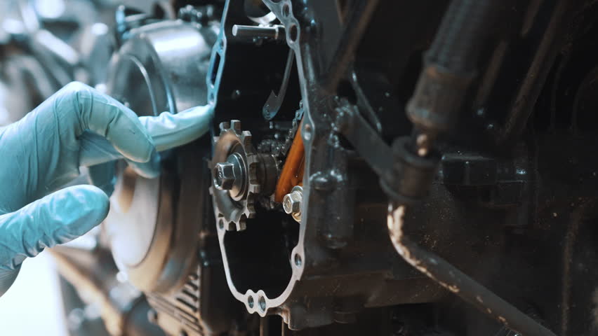 Motorcycle gear box refurbishment. Close up on hand removing excess oil from the frame. High quality 4k footage | Shutterstock HD Video #1102093735