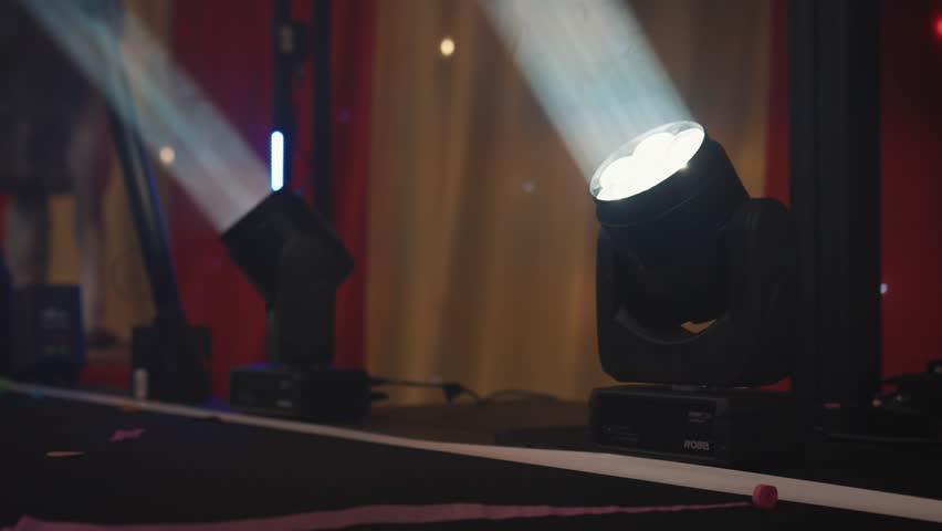 Disco lights, event lighting, spot lights, moving head lights, strobe lighting, beams and stage lighting, disco, party, wedding, celebration | Shutterstock HD Video #1102095675