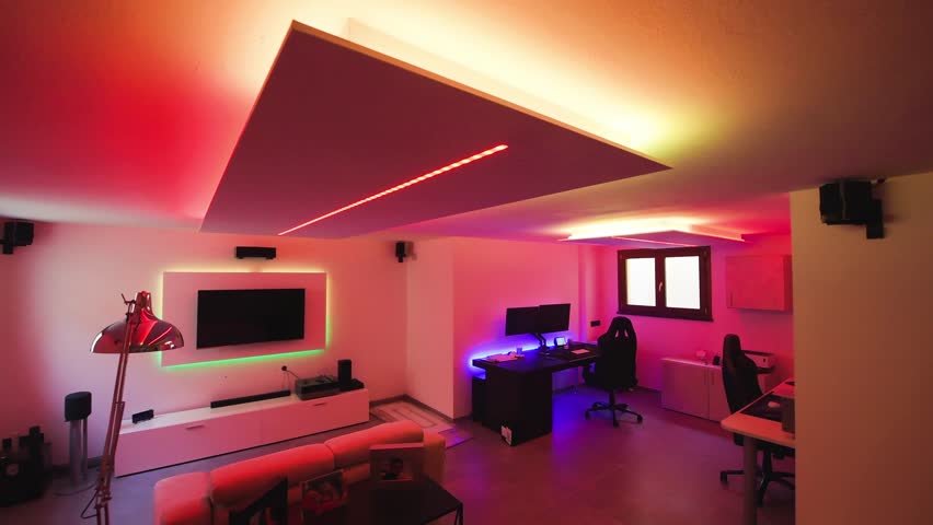 Modern room with bright led strips light. Tv, monitor and sofa