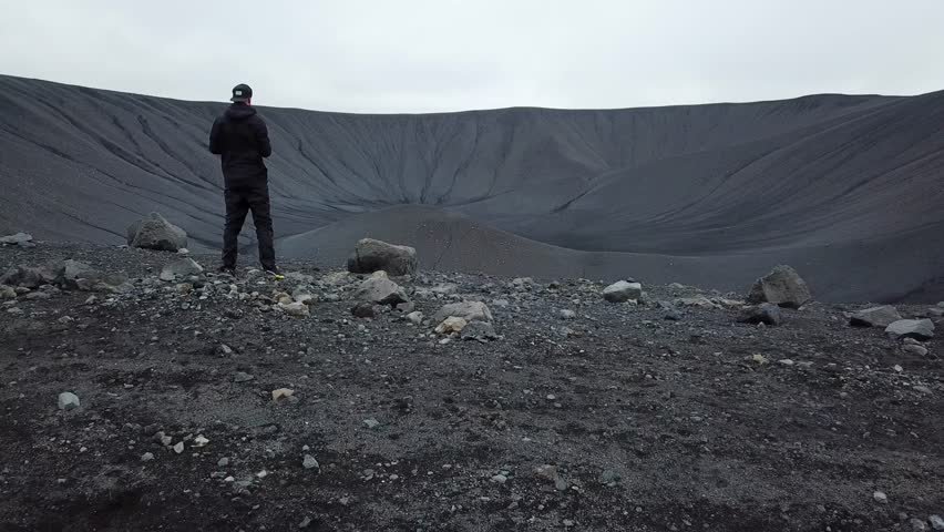 Aerial drone footage of an inactive Hverfjall volcano, Iceland. Cinematic aerial view of Hverfjall crater, a dormant volcano in Iceland. Man inside the volcano. High quality 4k footage