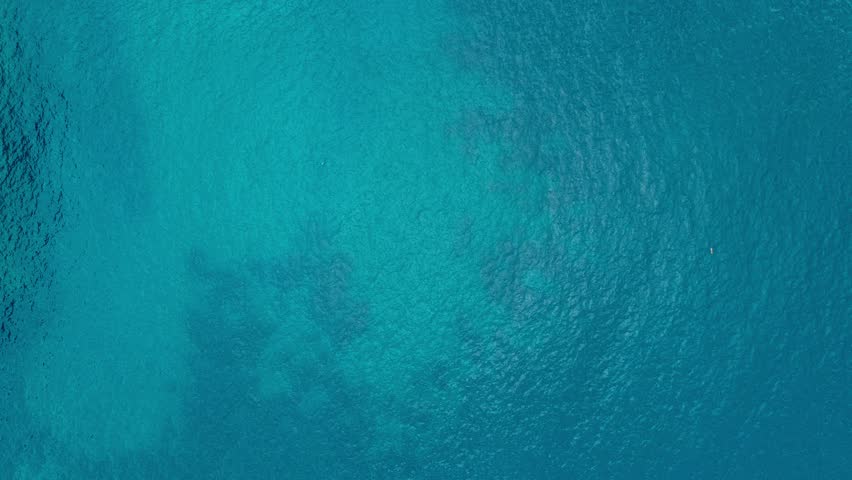 Aerial top down view from high altitude of blue azure turquoise sea water texture. a view of the water surface. Background of the water surface. 4k Royalty-Free Stock Footage #1102101725