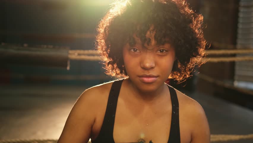 Outcry independent girl power. Angry african american woman fighter with boxing gloves looking serious aggressive to camera standing on boxing ring. Strong powerful girl looking concentrated straight Royalty-Free Stock Footage #1102105313