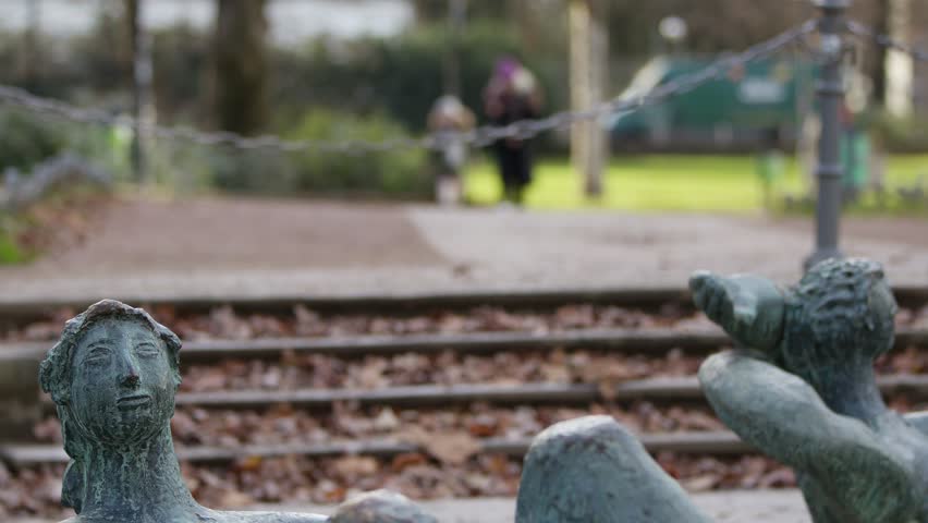 Statue in park in Frankfurt and People Blurry