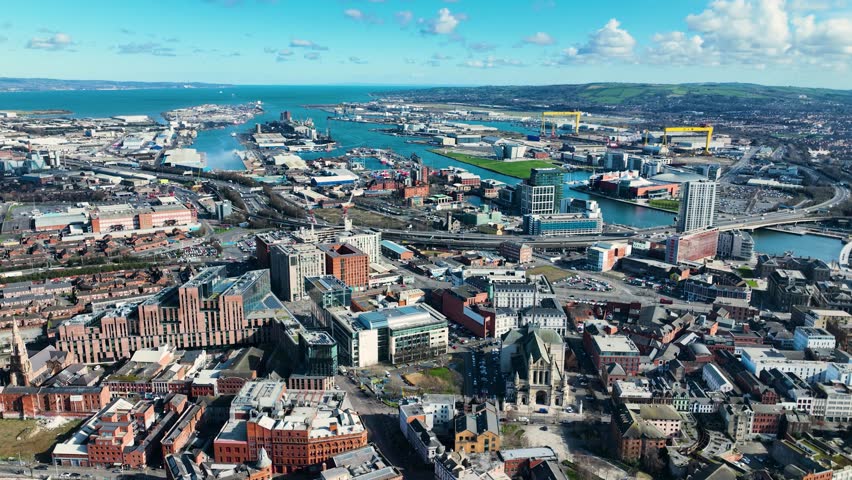 Aerial video of Belfast Cityscape Slyline on a sunny day in Northern Ireland  Royalty-Free Stock Footage #1102111457
