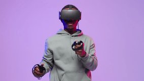 Afro american man is playing fighting game, box, using hands controllers in VR.