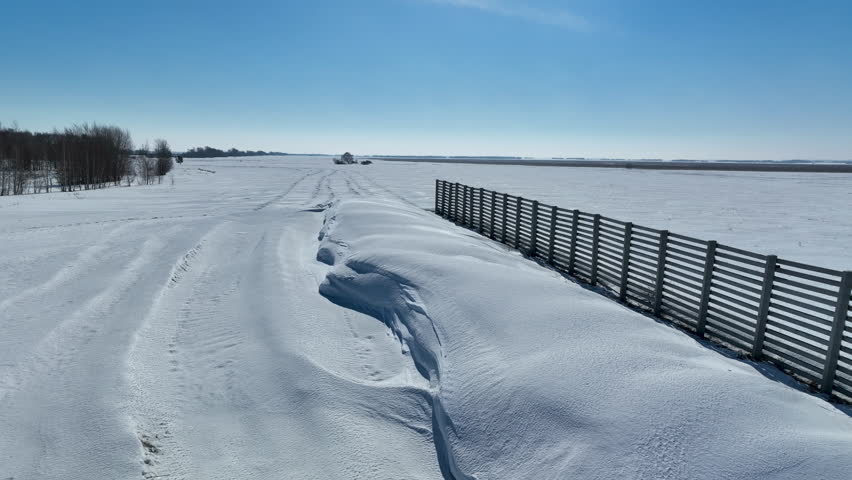 Snow fence for accumulation of snow and keeping most snow from blowing away in the wind. Kazakh steppe.