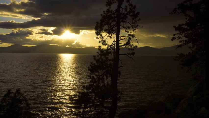 Sunset above Lake Tahoe in California with Sierra Nevada Mountains in the background. 4K UHD video.