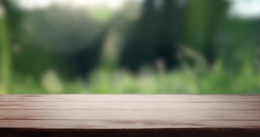 Wooden tabletop on focus with blurred defocused nature background. Table template. Tabletop montage for product presentation Royalty-Free Stock Footage #1102130203