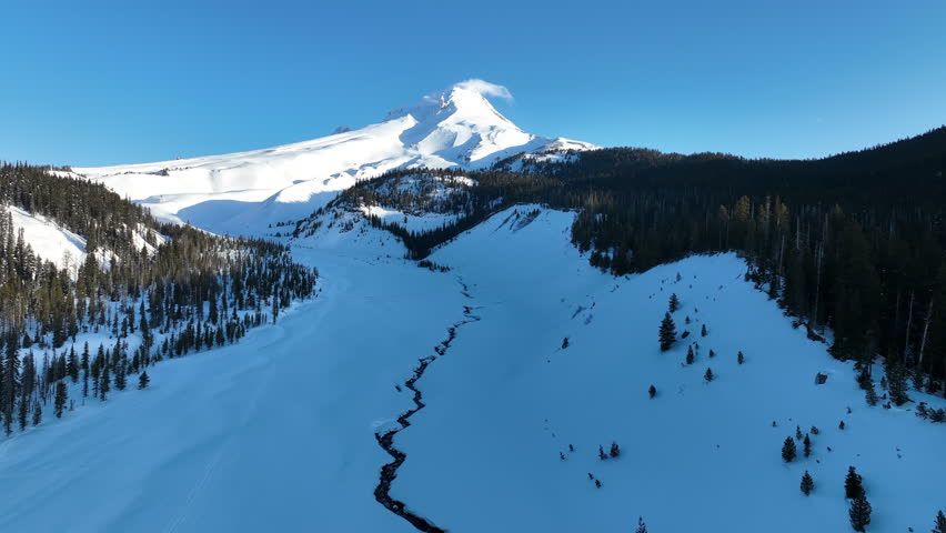 Early morning light shines on Mt Hood, an iconic stratovolcano found about 50 miles southeast of Portland, Oregon. Mt Hood has one of the longest ski seasons in the U.S. due to its annual snow pack.