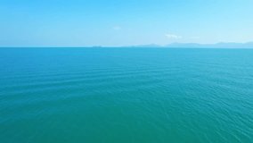 The sea and sky blend seamlessly together, creating an endless expanse of blue. The horizon appears to stretch out to infinity, making it difficult to discern where the sea ends and the sky begins.
