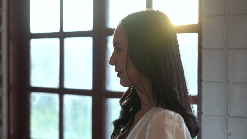 Cute Asian young couple embracing at home.