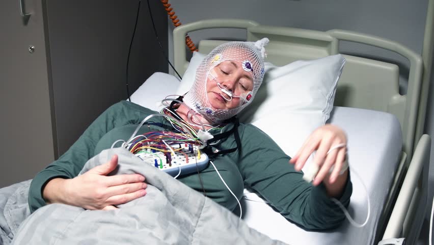 Middle aged woman measuring brain waves, examining polysomnography in sleep lab Royalty-Free Stock Footage #1102145869
