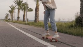 Hipster woman skateboarding on longboard having fun skating on the road while on beach vacation - Powered by Shutterstock - Get 15% off with code: PIKWIZARD15