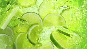 Super Slow Motion Shot of Fresh Lime Slices Falling into Lemonade Whirl at 1000 fps. - Powered by Shutterstock - Get 15% off with code: PIKWIZARD15