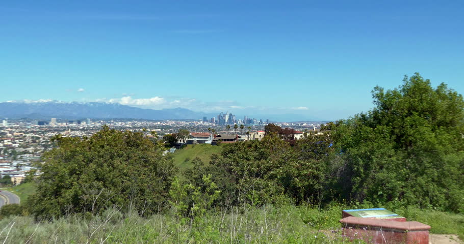 Aerial view of Los Angeles Downtown financial and business towers skyscrapers skyline and mountains in the background, California, 4K