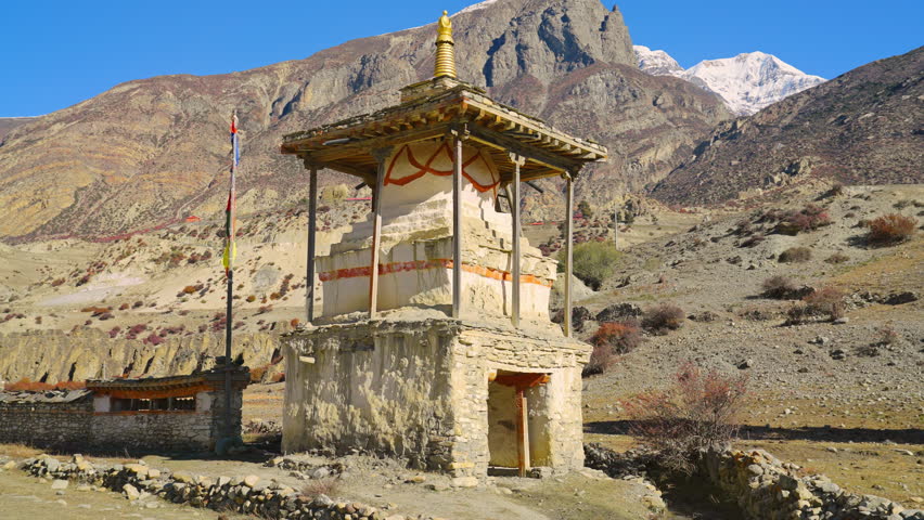 Parallax of traditional Buddhist Stupa in the Himalaya mountains on a sunny day, Annapurna Circuit Trek, Nepal Royalty-Free Stock Footage #1102152871