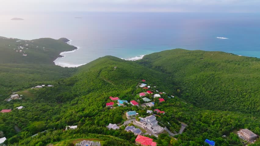 Aerial establishing shot of houses built on top of a mountain in St. Thomas, U.S. Virgin Islands