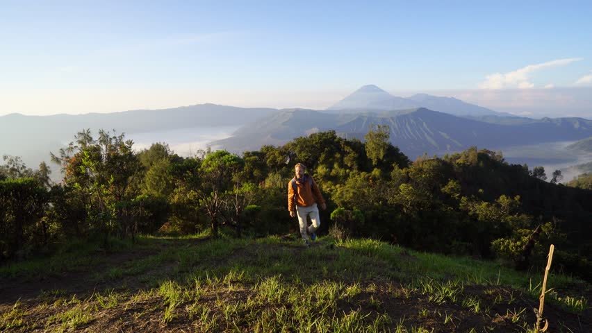Young man on a hike, hand reach out to help. A helping hand concept point of view 