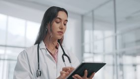 Internet, hospital and woman doctor with tablet, research email or medical results or networking on social media. Website search, healthcare and online surgery schedule or patient chart at clinic. - Powered by Shutterstock - Get 15% off with code: PIKWIZARD15