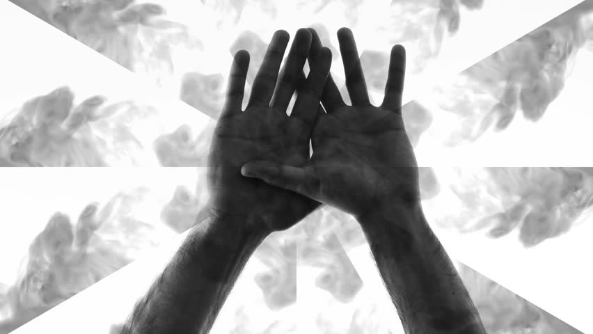 Computer graphics and double exposure. A kaleidoscope of swirling smoke against which two male hands rise, palms forward, and their fingers intertwine. Strange concept | Shutterstock HD Video #1102166851