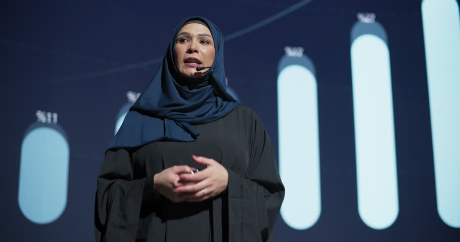 Business Expo Stage: Famous Inspirational Speaker From Gulf Region Talking about Technology, Science, Success, Productivity. Tech Industry Businesswoman in Traditional Arab Hijab Giving a Presentation | Shutterstock HD Video #1102168981