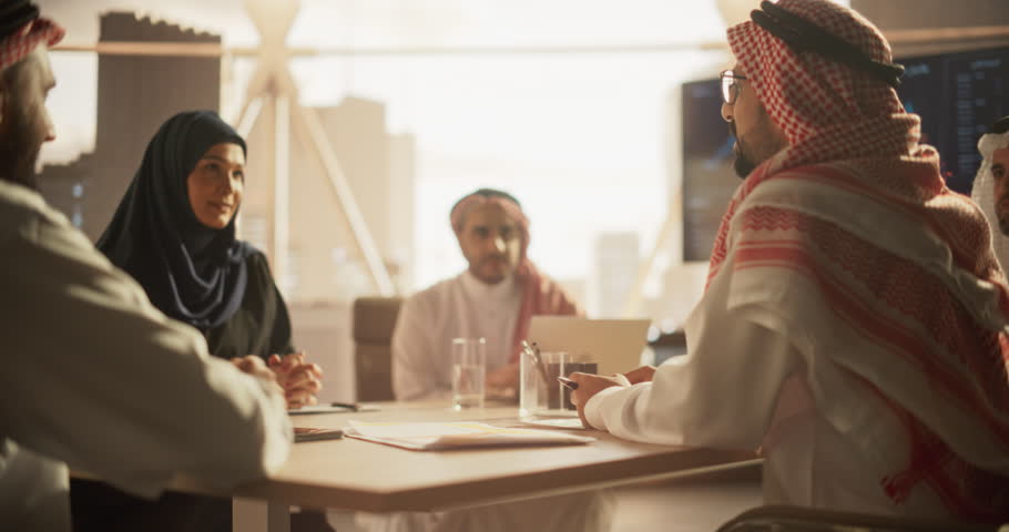 Muslim Businesspeople Closing a Business Deal at a Corporate Modern Office. Female and Male Representatives Shake Hands and Celebrate Successful Partnership. Saudi, Emirati, Arab Office Concept Royalty-Free Stock Footage #1102169069