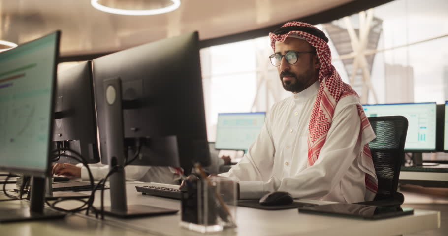 Portrait of a Smart Focused Middle Eastern Programmer Working on Computer in a Technological Corporate Office. Young Gulf Sales Manager Chatting With Corporate Business Partners Online Royalty-Free Stock Footage #1102169139